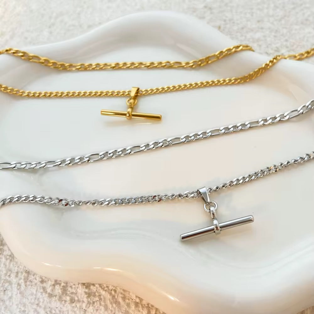 Multilayered T Bar Necklace-Elevate your style with our multilayered Figaro chain T-bar necklace, available in luxurious gold and sleek silver. This elegant piece features alternating long and short links with a chic T-bar clasp for a modern twist on a classic design. Crafted with 18k gold plating, it boasts a radiant, durable finish and is waterproof, ensuring lasting beauty and practicality. Enjoy free worldwide shipping and shop with confidence thanks to our 30-day satisfaction guarantee. Redefine sophis